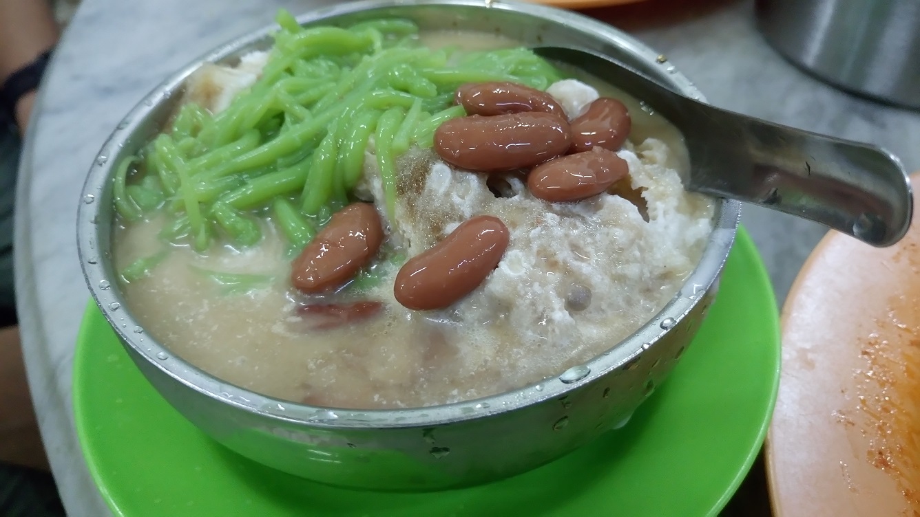 We saw many customers ordering the Cendol, and followed suit - it was good! Cendol = shaved ice with the green stuff (cendol) which is rice flour strips, coconut milk, palm sugar syrup, and here they added the kidney beans. A must-have on a hot day!