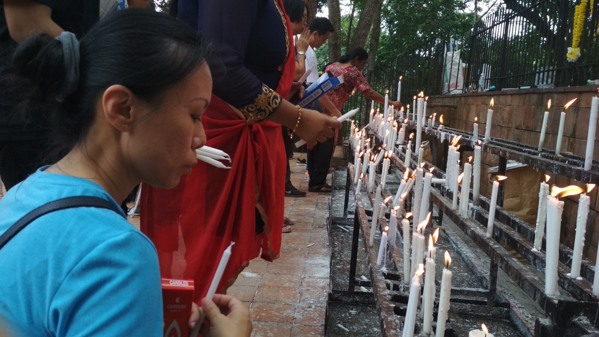 Lighting candle at the candle stand