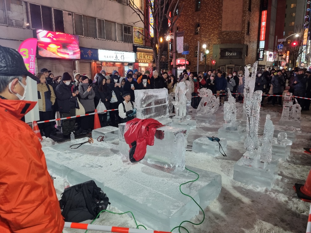 First up the artist cut a block of ice in half then angled the top bit slightly before joining it back together by pouring water from a bottle on it. I suppose the water would have frozen quickly as it was well below zero and getting colder fast.