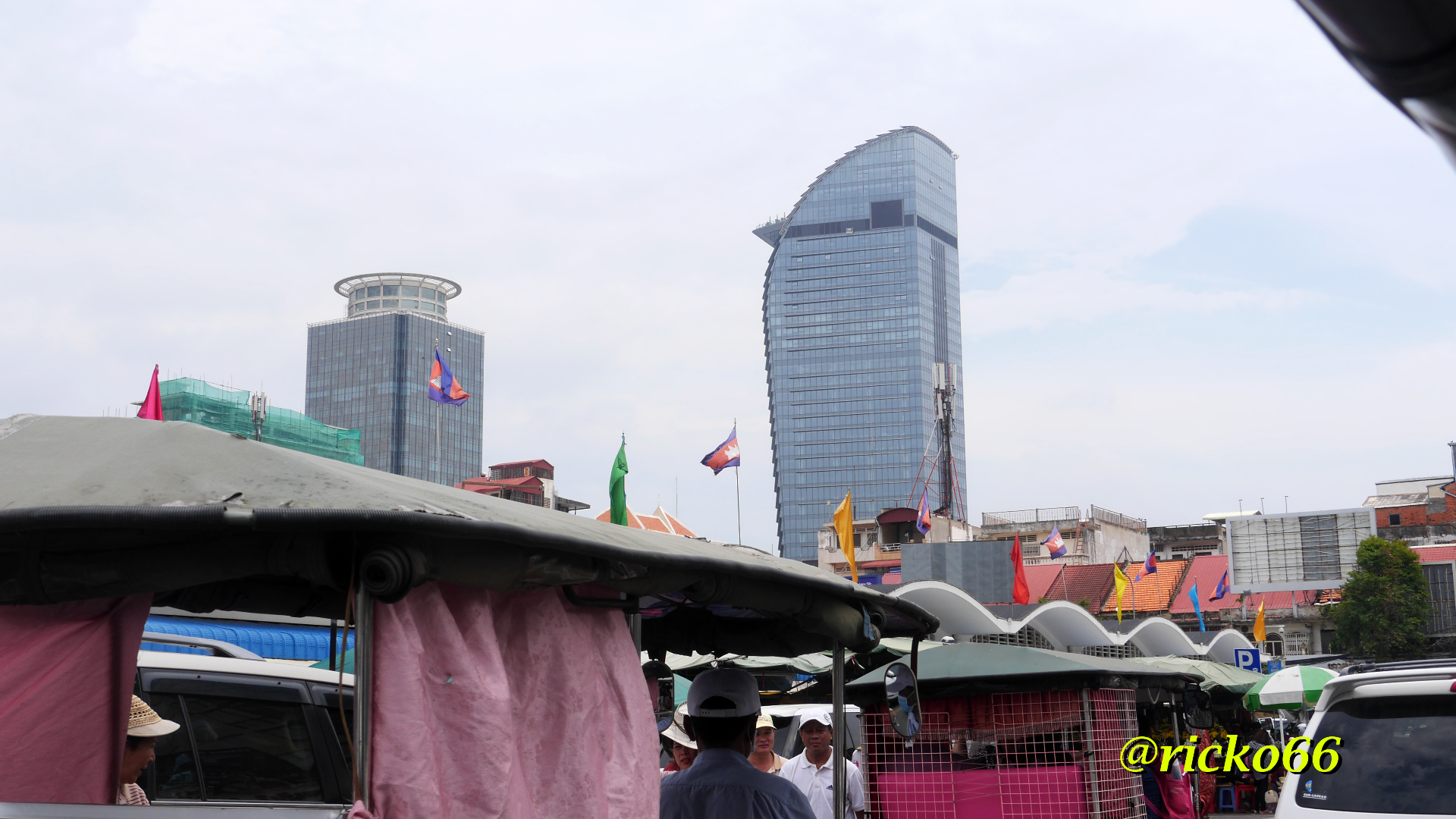 Tuk-tuk, cars, motorbikes, people everywhere in Phnom Penh traffic