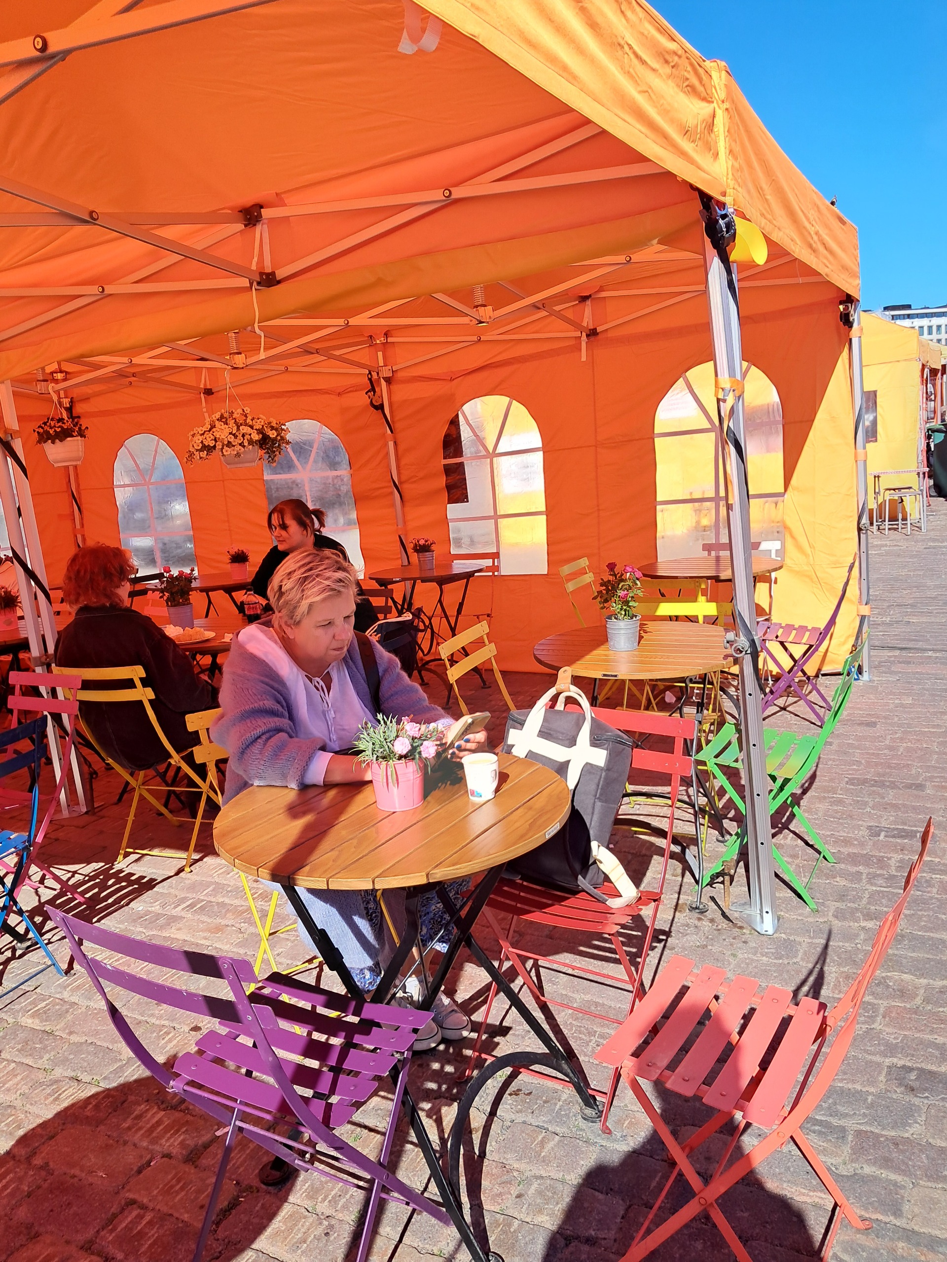 Drinking coffee in the market square in Helsinki, Finland 