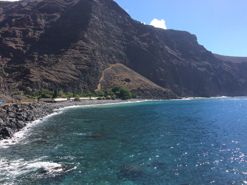 Rocky shore along the bay. The meditation center on the left.
